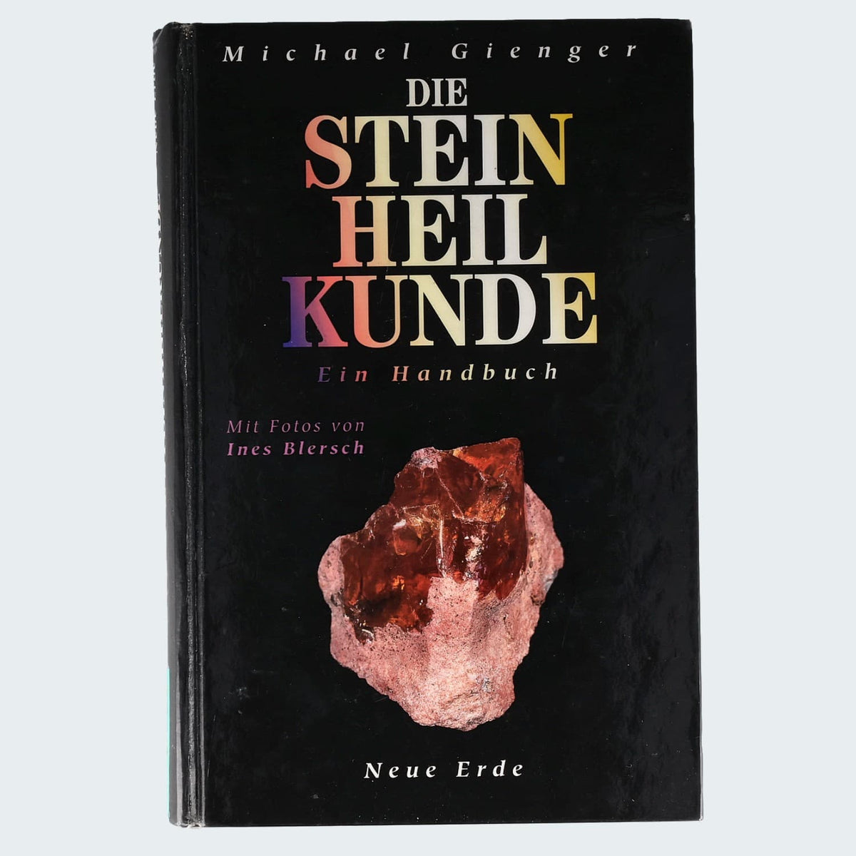 Michael Gienger, Die Steinheilkunde – Ein Handbuch – schwarze Vorderseite mit rotem Kristall auf Muttergestein